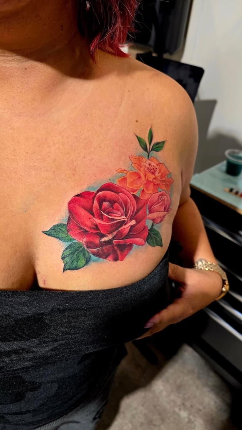 Red and orange roses in full colour across a collarbone
