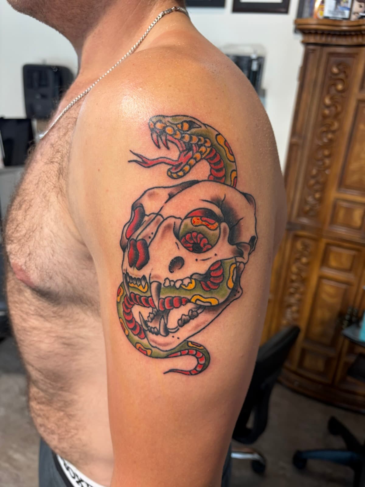 Rattlesnake coiled through a bear skull, colour on the shoulder