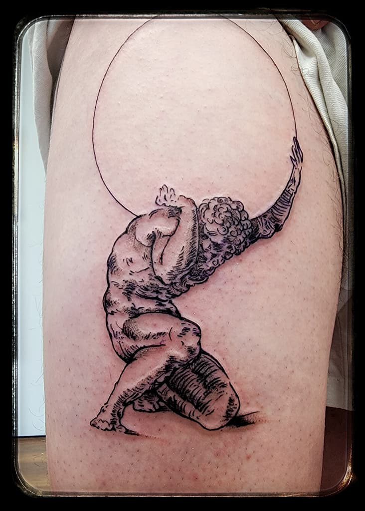 Kneeling figure of Atlas holding up an outlined circle, black and grey linework on the thigh