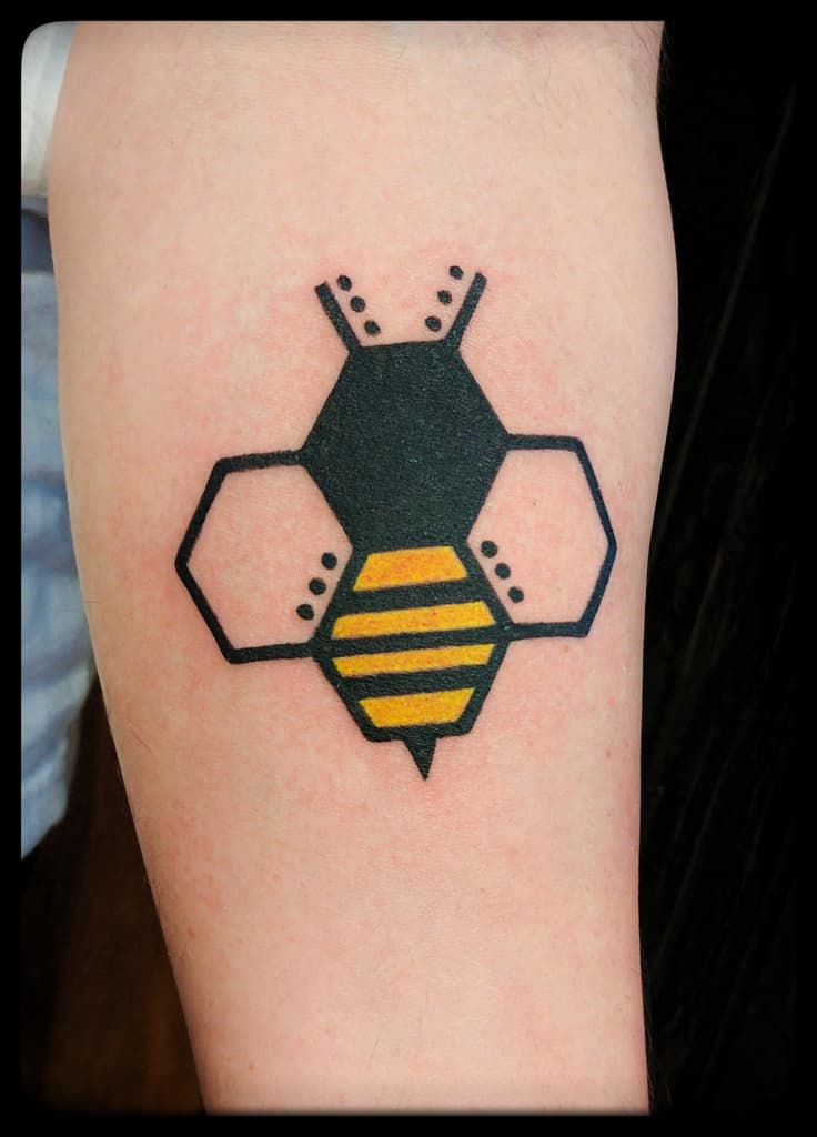 Geometric bee built from hexagons, solid black with yellow stripes on the forearm