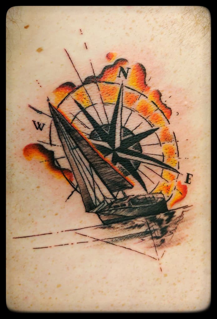 Sailboat over a compass rose with an orange and red watercolour splash, black and grey with colour
