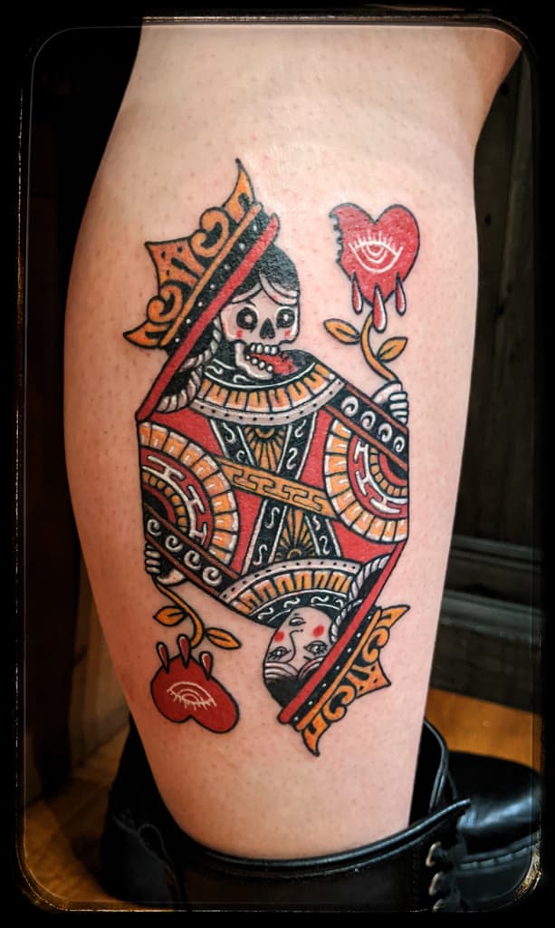 Queen playing card with a skeleton queen above and a human face below, traditional colour on the calf