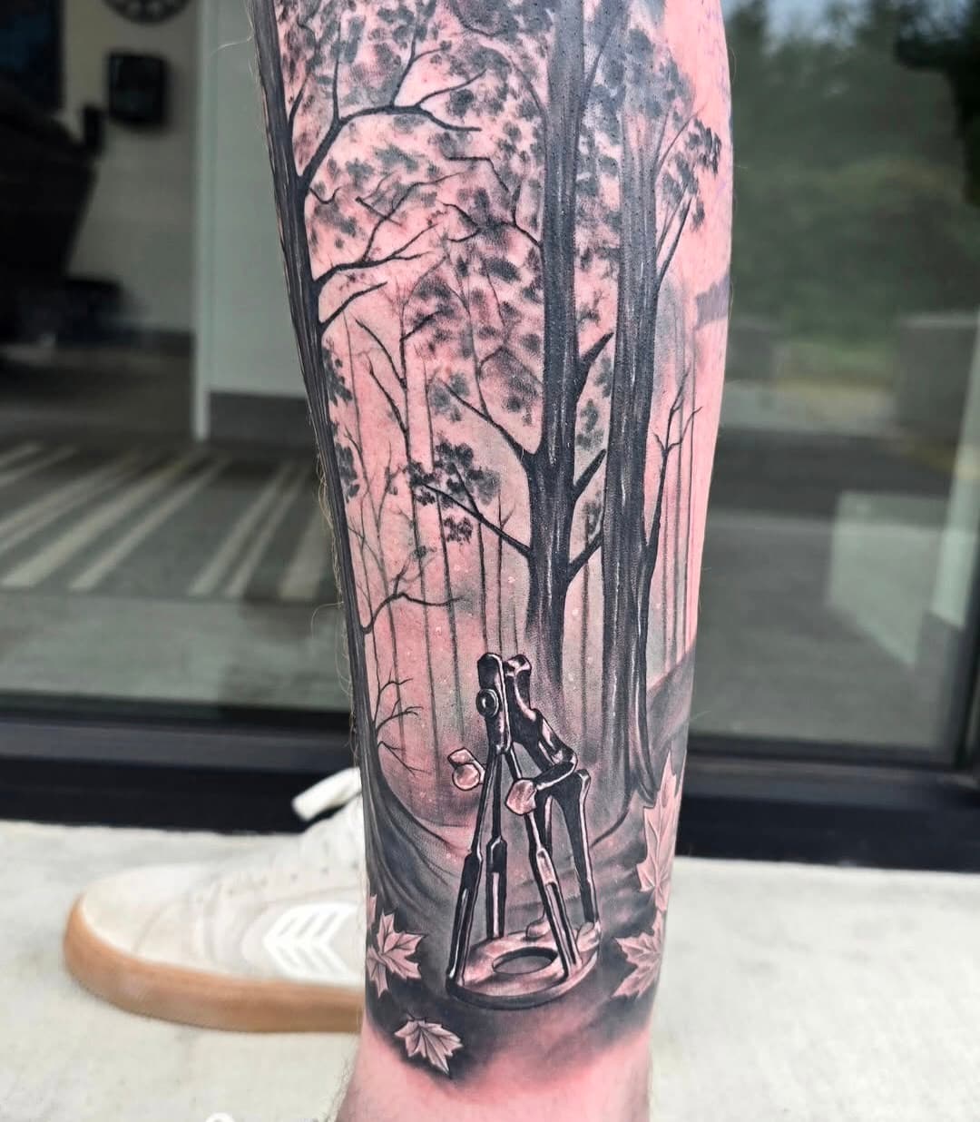 Figure walking through a tall pine forest, black and grey on the calf